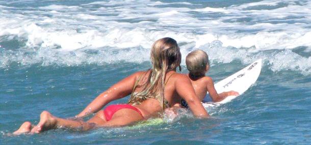 Jamilah and son Wiamea on a surf board in the waves in Mexico